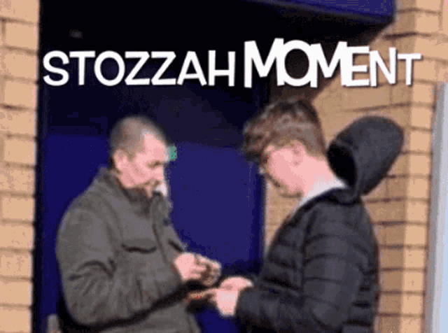 two men are standing in front of a building with the words stozzah moment written above them