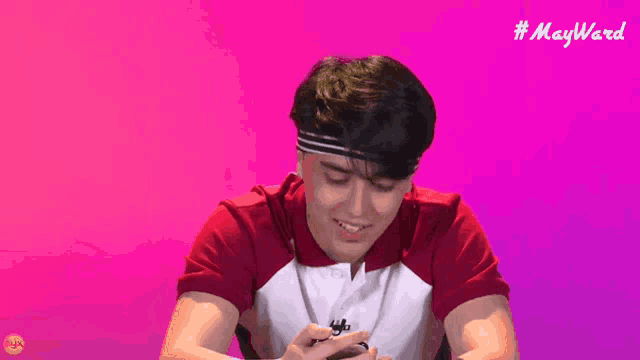 a man in a red and white shirt with the word may ward on the bottom right