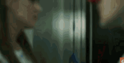 a blurry picture of a woman looking at herself in a mirror