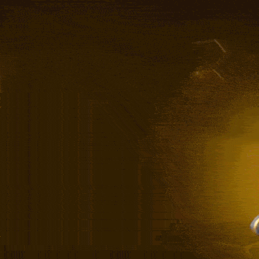 a blurred image of a person holding a gun with a yellow background