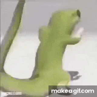 a close up of a green frog standing on a white surface with its arms outstretched .