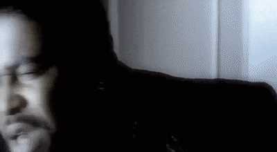 a blurry picture of a man 's face in a dark room with a window in the background .