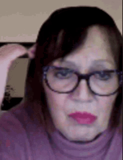 a close up of a woman wearing glasses and a turtleneck
