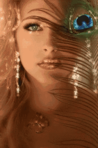 a woman with a peacock feather covering her face