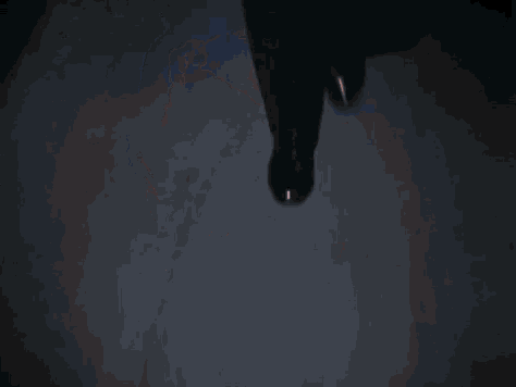 a close up of a man 's face in the dark with a blue light behind him .