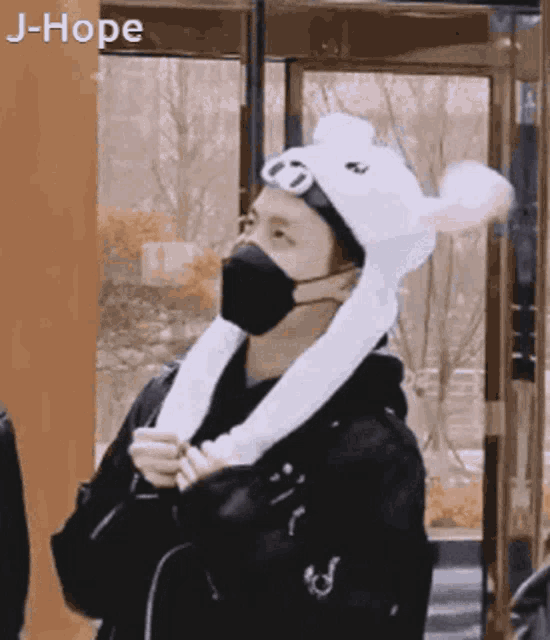 a person wearing a mask and a bunny hat