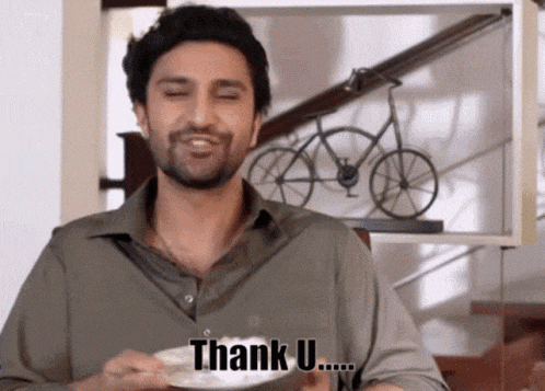 a man is holding a cup and saying thank u.