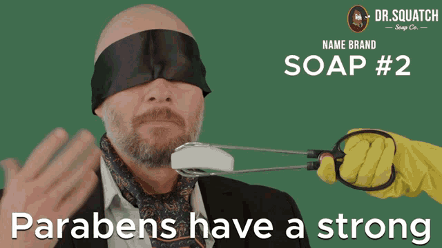 a man is blindfolded while someone holds a bar of soap in front of him and says parabens have a strong