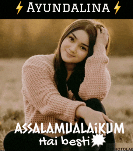 a woman in a pink sweater sits in a field with the words " assalamualaikum hai besti " written below her