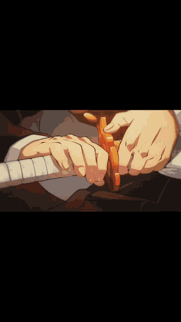 a close up of a person 's hand holding a sword in a dark room