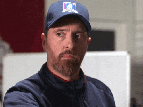 a man with a beard wearing a hat that says us open on it