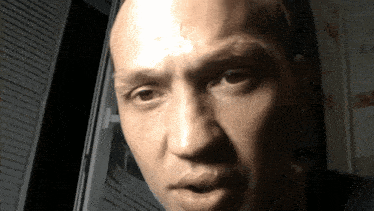 a close up of a man 's face with his eyes closed