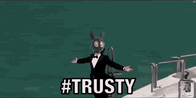 a man in a tuxedo is standing on a boat with his arms outstretched and the words `` trusty '' above him .