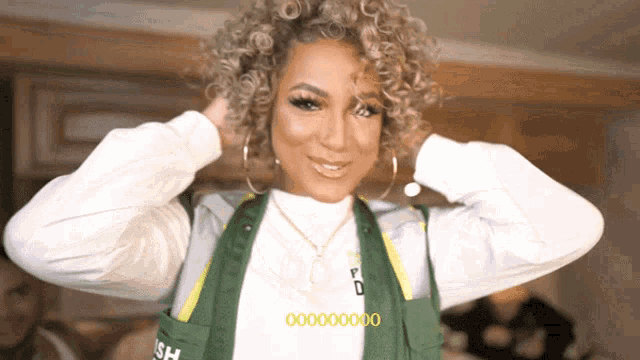 a woman wearing a green vest that says 000000
