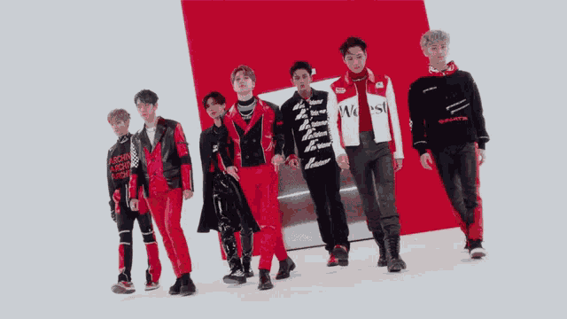 a group of young men standing next to each other with one wearing a shirt that says ' s.m.entertainment '