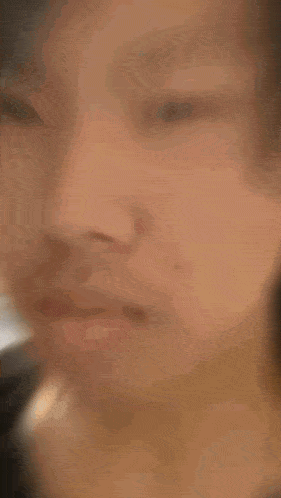 a blurry picture of a person 's face with a red nose