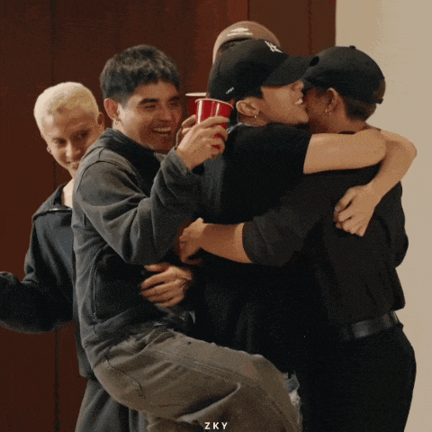 a group of people hugging each other with zky written on the bottom of the photo