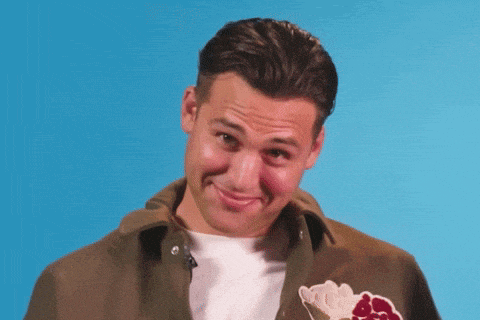 a man wearing a jacket with an ice cream cone on it makes a face