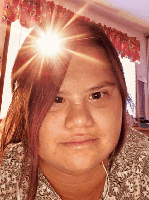 a girl with the sun shining on her face