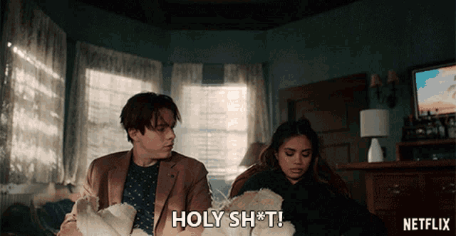 a netflix ad shows a man and a woman sitting on a couch
