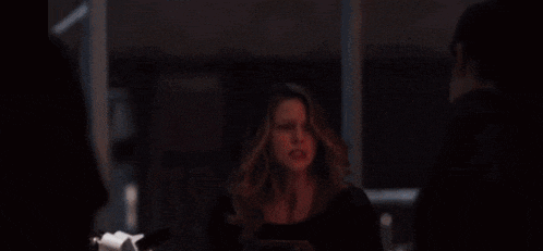 a person is holding a flamethrower in front of a mirror