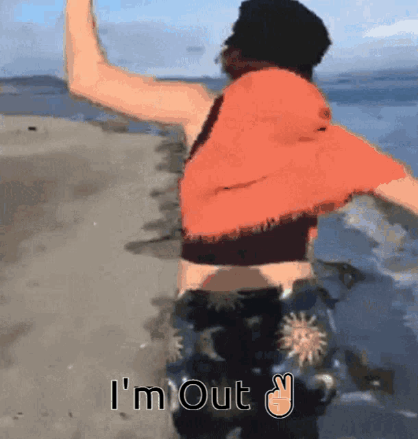 a person standing on a beach with the words i 'm out on the bottom
