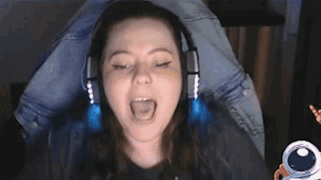a woman wearing headphones is sitting in a chair .