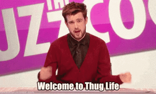 a man in a red sweater and tie is standing in front of a sign that says welcome to thug life .