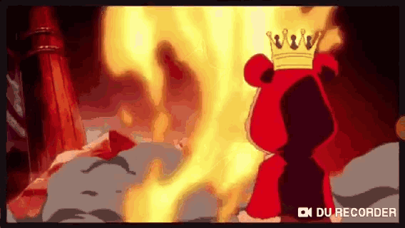 a cartoon character with a crown on his head stands in front of a fire .
