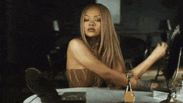 a woman is sitting at a table in front of a mirror .