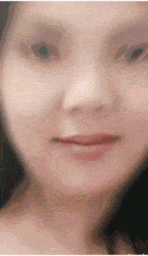 a woman 's face is shown in a blurry photo