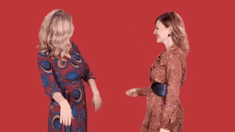 two women in dresses are standing next to each other