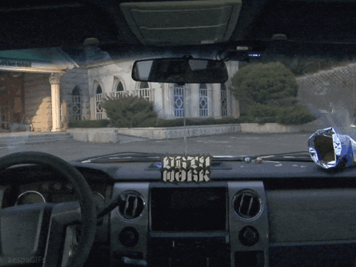 a car with a sign that says dirty work on the dashboard
