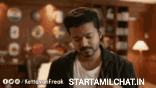 a man with a beard is standing in a room with the words starttamilchat.in above him