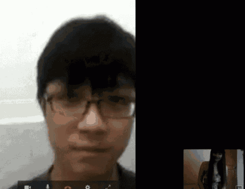 a man with glasses is on a video call with another man