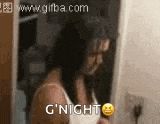 a woman in a white tank top is brushing her hair and says g 'night .