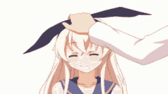 a person petting a girl 's head with a blue bow