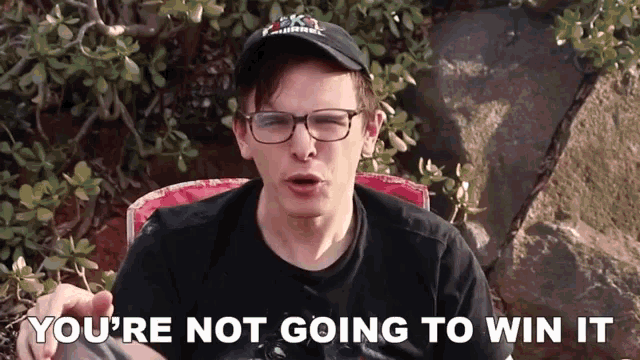 a man wearing glasses and a hat with the words you 're not going to win it