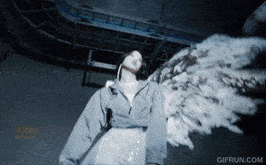 a woman with angel wings is standing in front of a gif run.com logo