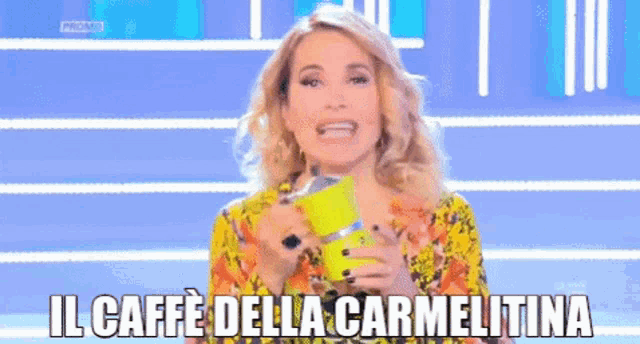 a woman is holding a yellow cup and says il caffe della carmellina
