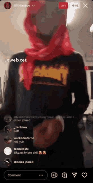 a man wearing a red scarf and a black shirt with the word jewelxet on it
