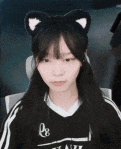 a girl wearing a cat ear headband and a shirt that says 08