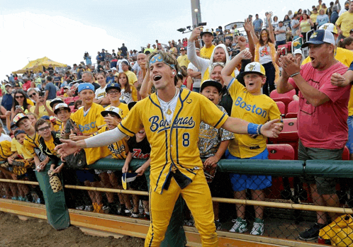 a man wearing a yellow jersey that says boston on it