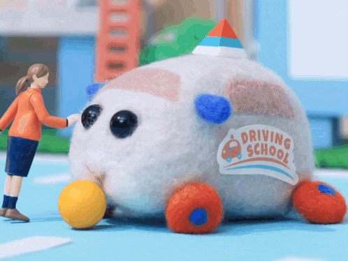 a stuffed animal with the word driving school on it