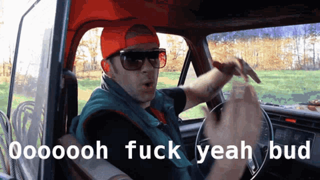 a man wearing sunglasses and a red hat is driving a truck and says " ooooh fuck yeah bud " on the bottom