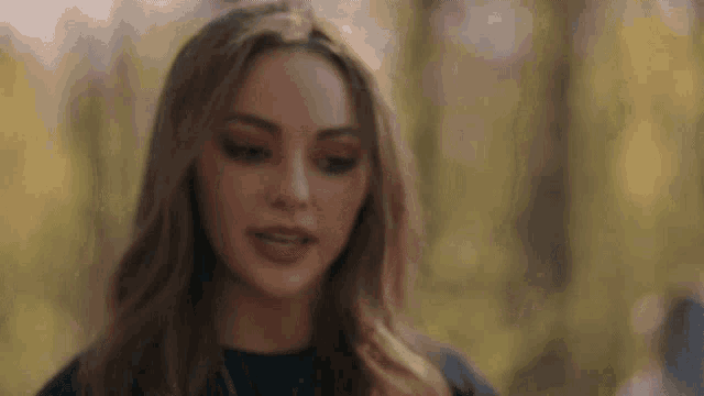 a close up of a woman 's face with a blurry background .