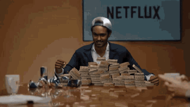 a man holding a pile of money in front of a netflix sign