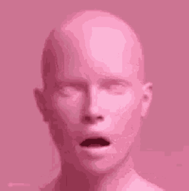 a close up of a pink mannequin 's head with its mouth open .