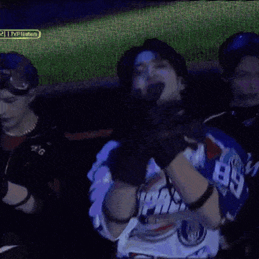 a man wearing a supreme jersey is dancing on stage