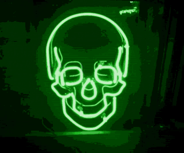 a green and purple skull with headphones and glasses
